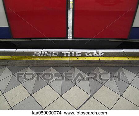 Mind the gap warning painted on the edge of the subway platform in the London Underground View Large Photo Image Picture - Mind the gap warning painted on the edge of the subway platform in the London Underground. Fotosearch