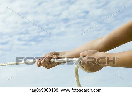 Person pulling end of rope with both hands View Large Photo Image Stock Image - Person pulling end of rope with both hands. Fotosearch