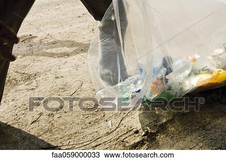 Picking up trash outdoors View Large Photo Image Stock Image - Picking up trash outdoors. Fotosearch