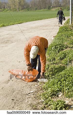Picking up trash outdoors View Large Photo Image Stock Photo - Picking up trash outdoors. Fotosearch