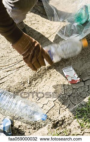 Stock Image - Picking up trash. Fotosearch