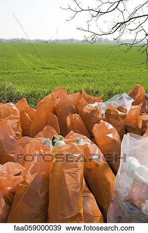 Pile of garbage bags beside field View Large Photo Image Stock Photo - Pile of garbage bags beside field. Fotosearch