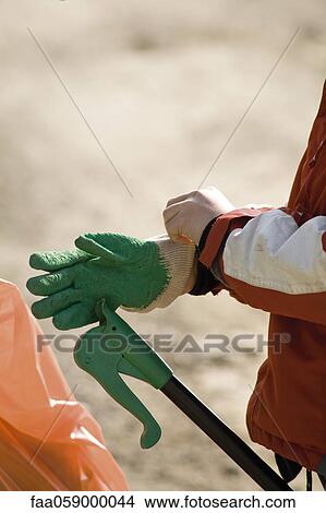 Putting on glove View Large Photo Image Picture - Putting on glove. Fotosearch