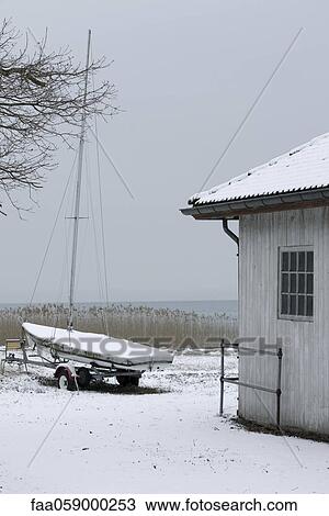 Sailboat ashore in wintery scene View Large Photo Image Stock Image - Sailboat ashore in wintery scene. Fotosearch