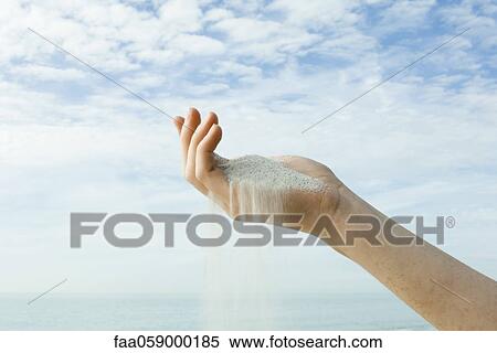 Sand spilling from cupped hand View Large Photo Image Stock Photography - Sand spilling from cupped hand. Fotosearch