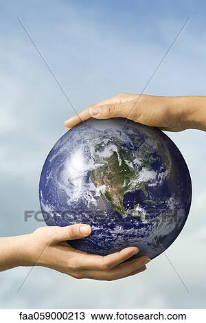 Two people's hands supporting one ball View Large Photo Image Stock Image - Two people's hands supporting one ball. Fotosearch