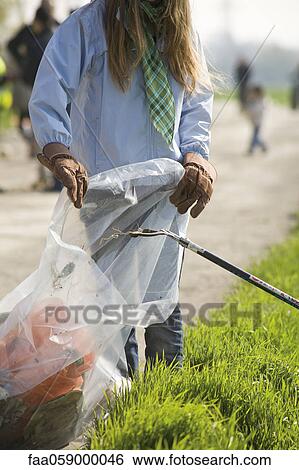 Volunteers cleaning up trash outdoors View Large Photo Image Stock Photograph - Volunteers cleaning up trash outdoors. Fotosearch