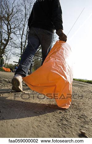 Walking with garbage bag View Large Photo Image Stock Image - Walking with garbage bag. Fotosearch