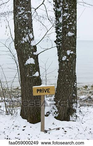 Stock Photo - Wintery scene with sign reading "private" in French. Fotosearch