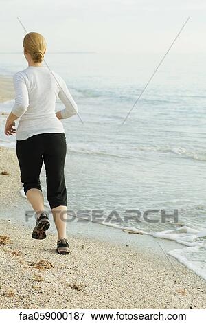 Woman jogging at the beach View Large Photo Image Stock Photo - Woman jogging at the beach. Fotosearch
