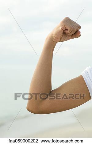 Woman's arm flexing View Large Photo Image Stock Image - Woman's arm flexing. Fotosearch
