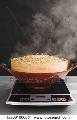 Cooking with steamer basket View Large Photo Image Picture - Cooking with steamer basket. Fotosearch