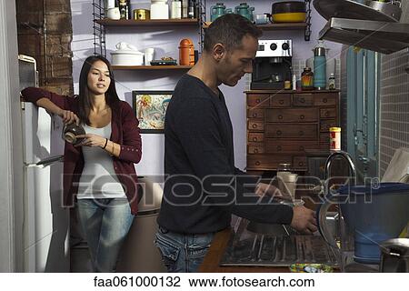 Couple in kitchen, husband doing dishes View Large Photo Image Stock Image - Couple in kitchen, husband doing dishes. Fotosearch