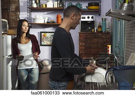 Couple in kitchen, husband doing dishes View Large Photo Image Stock Image - Couple in kitchen, husband doing dishes. Fotosearch