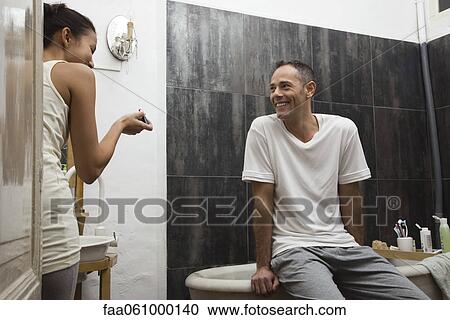 Couple talking and laughing in bathroom View Large Photo Image Stock Image - Couple talking and laughing in bathroom. Fotosearch