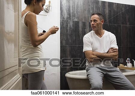 Couple talking in bathroom View Large Photo Image Stock Image - Couple talking in bathroom. Fotosearch