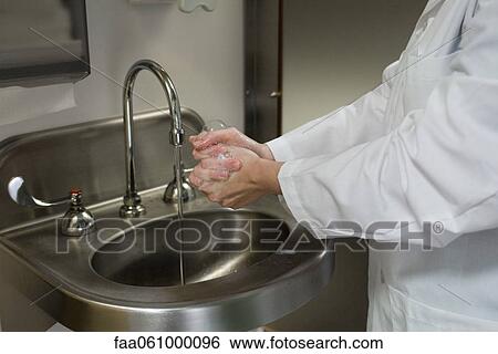 Healthcare professional washing hands, cropped View Large Photo Image Stock Photograph - Healthcare professional washing hands, cropped. Fotosearch