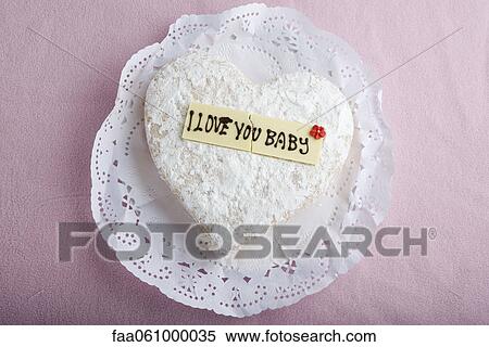 Heart-shaped pastry with lettering on decorative white chocolate reading, "I love you baby" View Large Photo Image Stock Photography - Heart-shaped pastry with lettering on decorative white chocolate reading, "I love you baby". Fotosearch