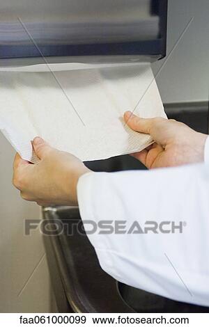 Taking paper towel from dispenser View Large Photo Image Stock Photo - Taking paper towel from dispenser. Fotosearch