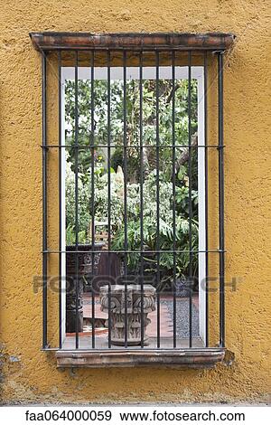 Barred window looking into courtyard View Large Photo Image Stock Photo - Barred window looking into courtyard. Fotosearch