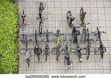 Bicycles parked in bicycle rack, overhead view View Large Photo Image Stock Image - Bicycles parked in bicycle rack, overhead view. Fotosearch