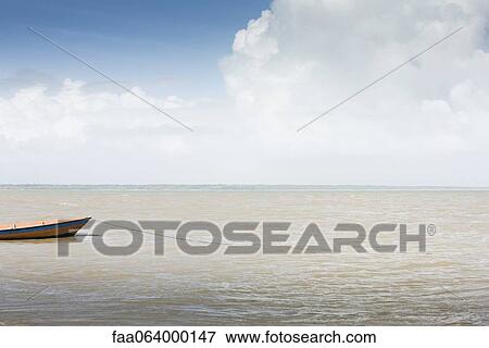 Boat moored in shallow water View Large Photo Image Stock Photo - Boat moored in shallow water. Fotosearch