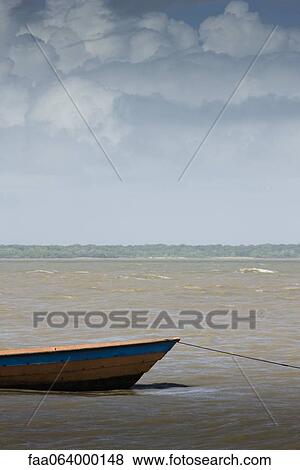 Boat moored in shallow water View Large Photo Image Stock Photo - Boat moored in shallow water. Fotosearch