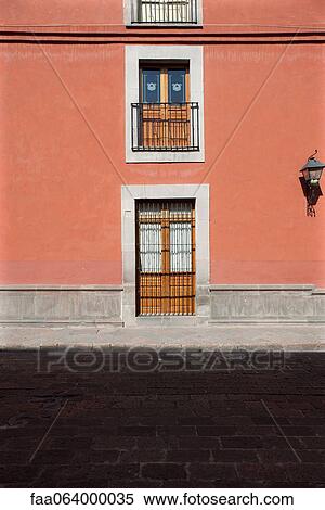 Stock Photography - Colorful building with barred doors and windows. Fotosearch