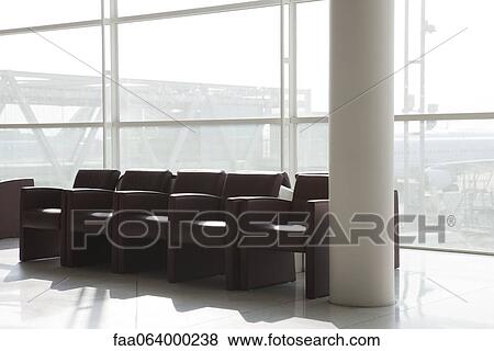 Empty armchairs in airport terminal View Large Photo Image Stock Photo - Empty armchairs in airport terminal. Fotosearch