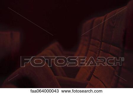 Stock Image - Empty theater seats in folded position. Fotosearch
