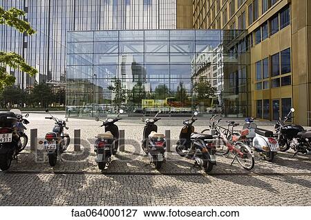 Stock Photo - Germany, Berlin, mopeds parked in front of Axel Springer publishing house. Fotosearch