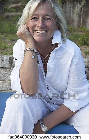 Mature woman relaxing outdoors, portrait View Large Photo Image Stock Image - Mature woman relaxing outdoors, portrait. Fotosearch