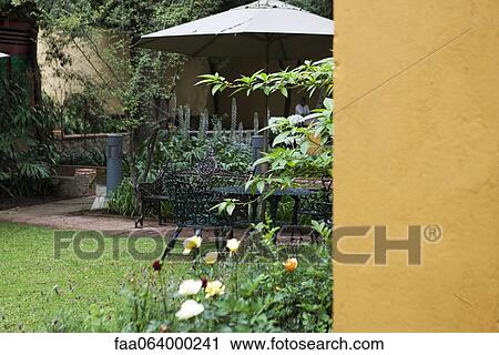 Stock Image - Patio furniture in garden. Fotosearch