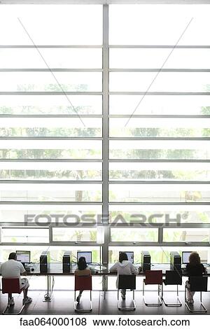 People using computers in modern building View Large Photo Image Stock Photo - People using computers in modern building. Fotosearch