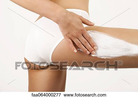Woman applying moisturizer to thigh, cropped View Large Photo Image Stock Photo - Woman applying moisturizer to thigh, cropped. Fotosearch