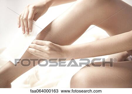 Woman waxing legs, cropped View Large Photo Image Stock Image - Woman waxing legs, cropped. Fotosearch