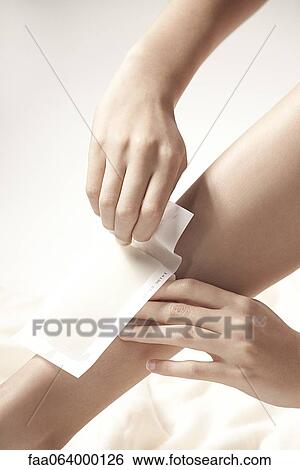 Woman waxing legs, cropped View Large Photo Image Stock Photograph - Woman waxing legs, cropped. Fotosearch