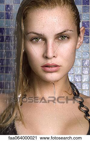 Stock Image - Young woman in shower, portrait. Fotosearch