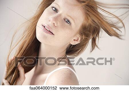 Young woman with hair blowing in breeze, portrait View Large Photo Image Stock Image - Young woman with hair blowing in breeze, portrait. Fotosearch