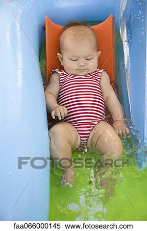 Baby playing in kiddy pool, portrait View Large Photo Image Stock Photography - Baby playing in kiddy pool, portrait. Fotosearch