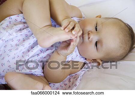 Baby playing with foot, portrait View Large Photo Image Picture - Baby playing with foot, portrait. Fotosearch