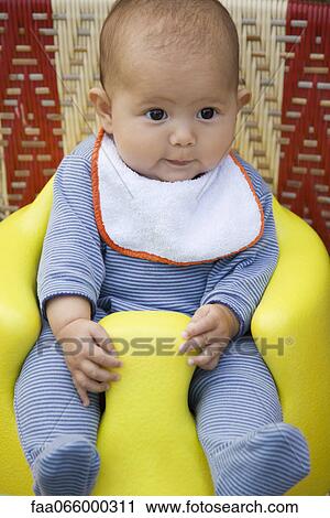 Baby sitting on booster seat, portrait View Large Photo Image Stock Image - Baby sitting on booster seat, portrait. Fotosearch