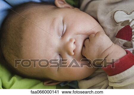 Baby sleeping with fingers in mouth View Large Photo Image Stock Image - Baby sleeping with fingers in mouth. Fotosearch