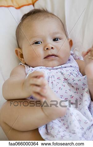 Baby touching feet, portrait View Large Photo Image Picture - Baby touching feet, portrait. Fotosearch