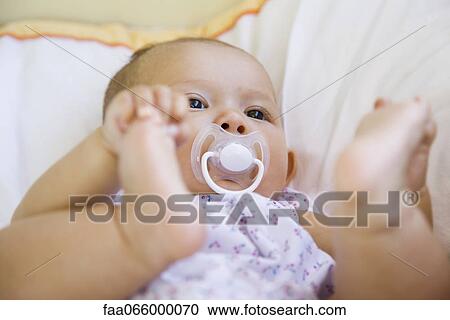 Baby touching feet, portrait View Large Photo Image Stock Image - Baby touching feet, portrait. Fotosearch