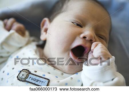 Stock Image - Baby yawning, portrait. Fotosearch