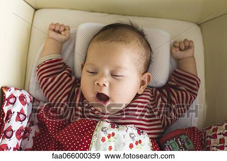 Stock Photo - Baby yawning, portrait. Fotosearch