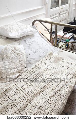 Bed covered with crocheted blanket View Large Photo Image Stock Image - Bed covered with crocheted blanket. Fotosearch