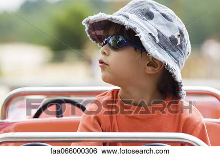 Boy on amusement park ride, portrait View Large Photo Image Stock Photograph - Boy on amusement park ride, portrait. Fotosearch