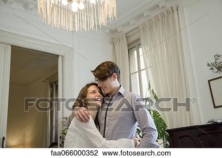Stock Image - Couple embracing at home. Fotosearch